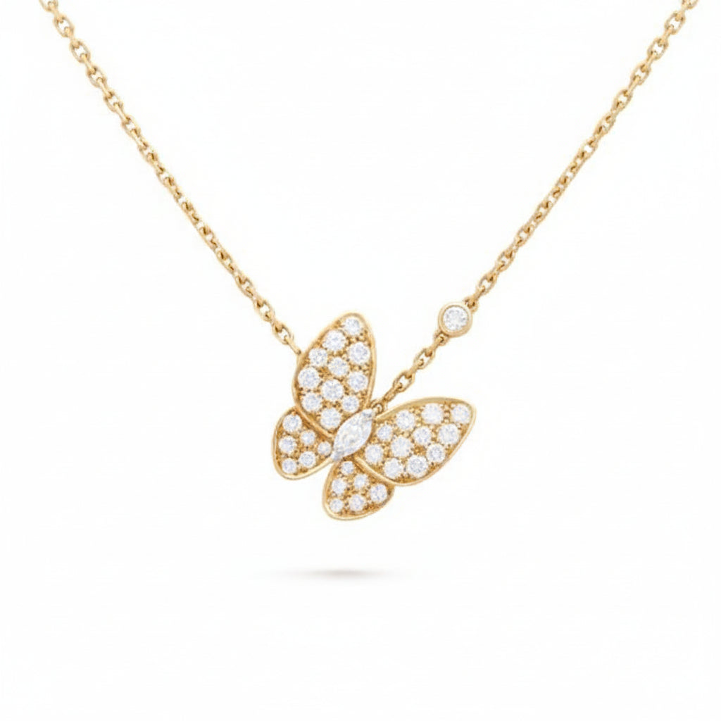 Gold butterfly necklace with diamond accents on a white background