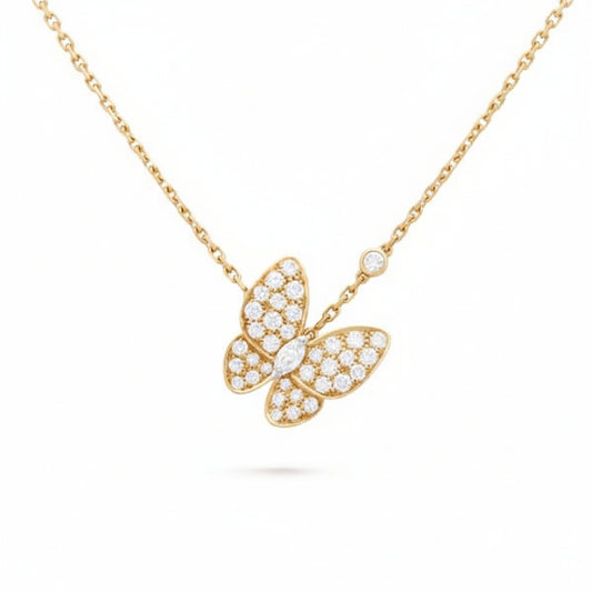 Gold butterfly necklace with diamond accents on a white background