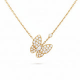 Gold butterfly necklace with diamond accents on a white background